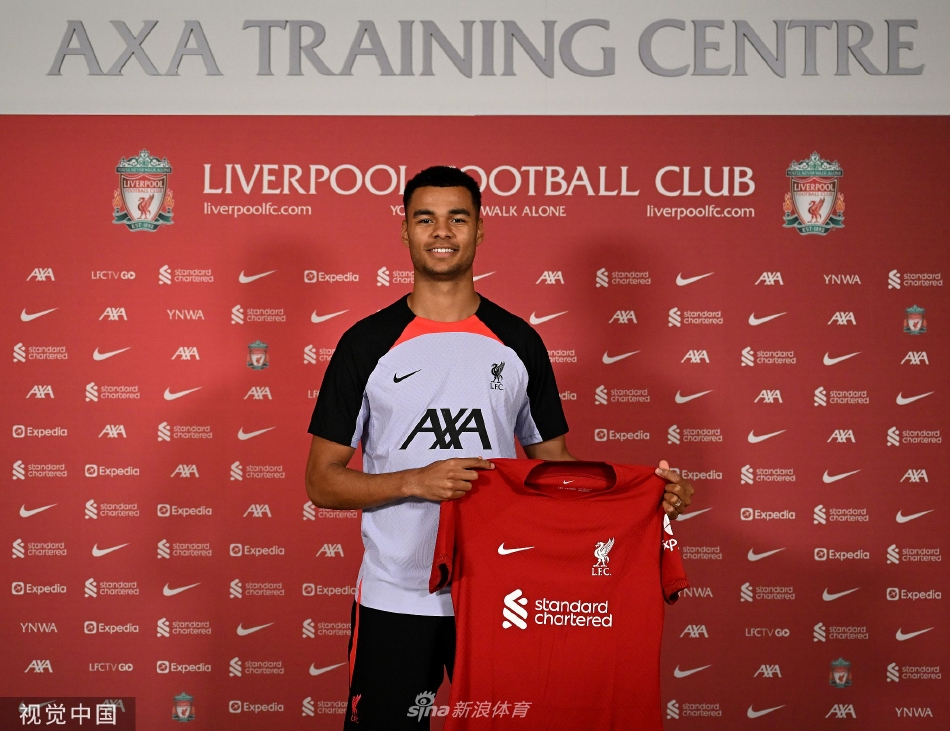 加克波手持利物浦18号球衣，于俱乐部标志前展示灿烂笑容，眼中充满对未来的期待。