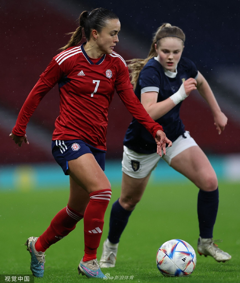 苏格兰女足队长卡罗琳·威尔在比赛中带球突破，神情专注，展现出高超的控球技巧和领袖风范。