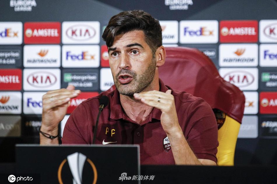 一名罗马球员（可能是代表出席的队长）在发布会后独自离场，背影坚定，背后的通道灯光将他轮廓勾勒得格外清晰，预示着即将踏上战场的勇士背影。