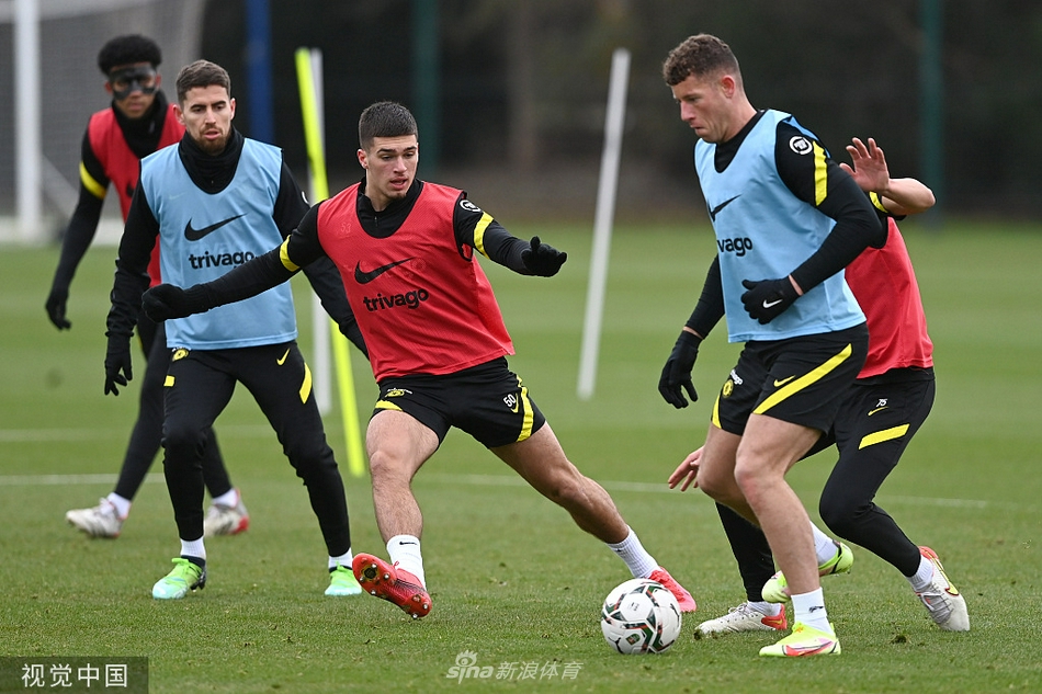 球队助理教练正在向一群队员详细讲解战术板，队员们聚精会神聆听，领悟即将执行的比赛策略。