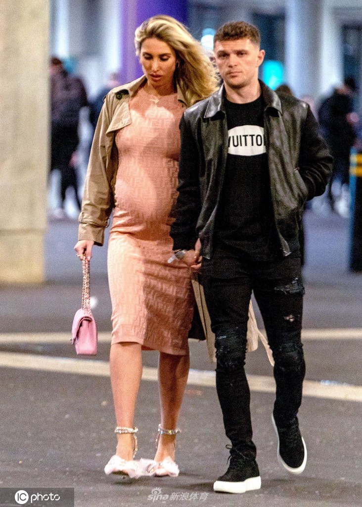 特里皮尔与女友在比赛现场深情对望，两人脸上洋溢着幸福的笑容，共享这个充满激情与速度的体育之夜。