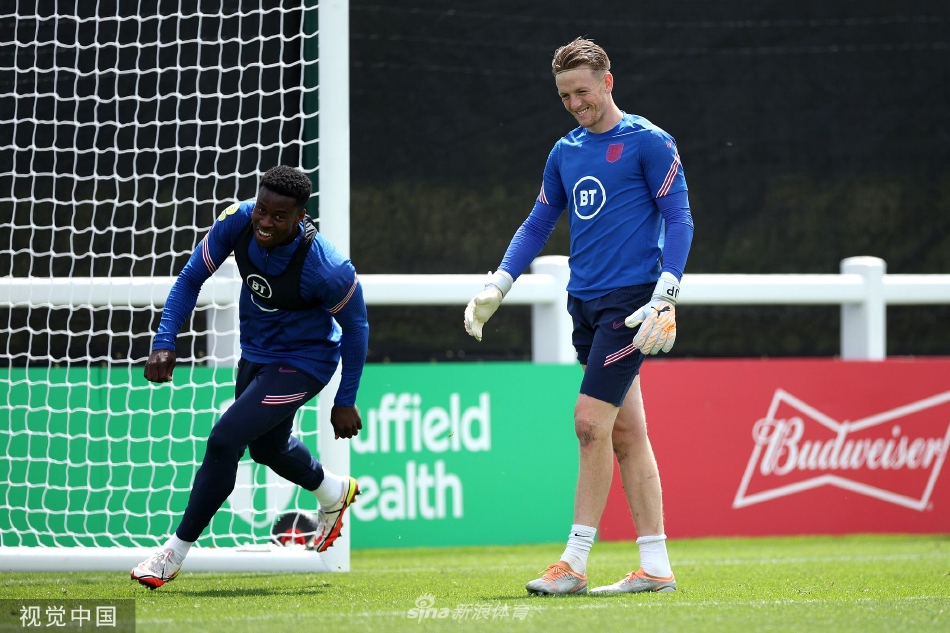 英格兰队正在进行高强度的分组对抗演练。一名中场球员正试图从两名队友的围抢中护住足球，激烈的身体对抗展现了训练课的高质量与实战性。