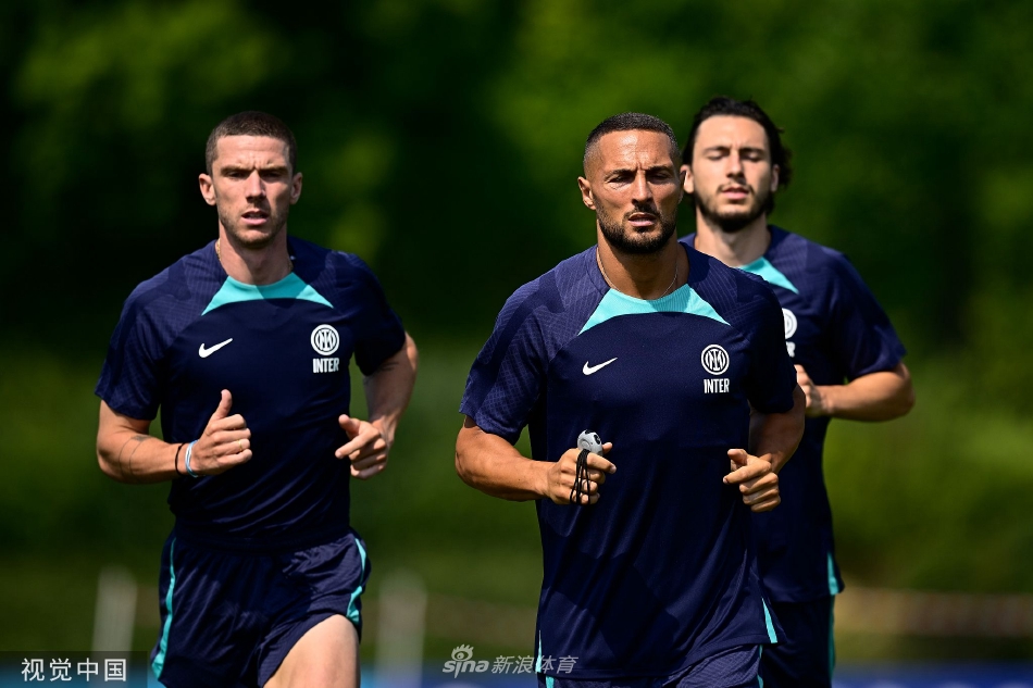 全队在进行拉伸放松，背景是国际米兰训练中心的现代化设施，体现了俱乐部专业、科学的备战环境。