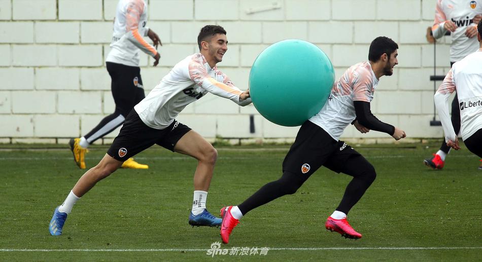 画面中，两名瓦伦西亚球员正在进行激烈的拼抢对抗，空气中弥漫着“火药味”，球衣上的汗水在阳光下闪闪发光，这场训练的强度丝毫不逊于正式比赛，每一次触球都是对胜利的渴望。
