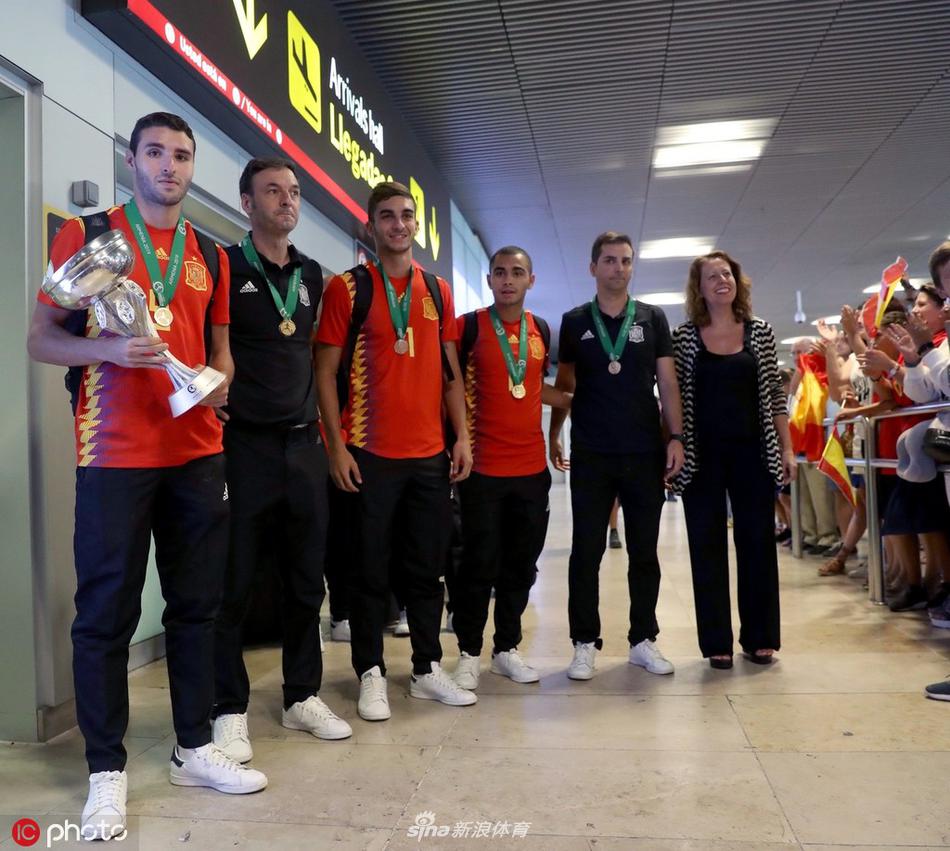 队长阿贝尔-鲁伊斯紧紧抱着冠军奖杯，仿佛拥抱着整个世界。在他身旁，队友们纷纷伸出手来触摸这份至高无上的荣誉，大家的目光都聚焦在金色的奖杯上，画面中洋溢着满满的团队凝聚力和自豪感。