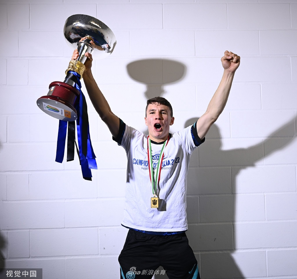国际米兰青年队队长将闪闪发光的冠军奖杯高高举过头顶，全体队员环绕着他爆发出胜利的呐喊