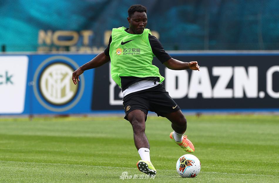 卢卡库在对抗训练中露出标志性的笑容，庞大的身躯在阳光下投射出充满力量感的影子