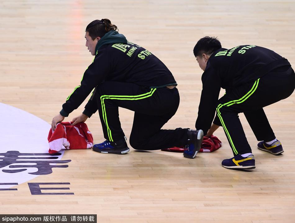 辽宁主场对阵广东比赛中,球员们暂停间隙大汗淋漓,而身穿黄马甲的场地志愿者抓住时机迅速清理地面汗水
