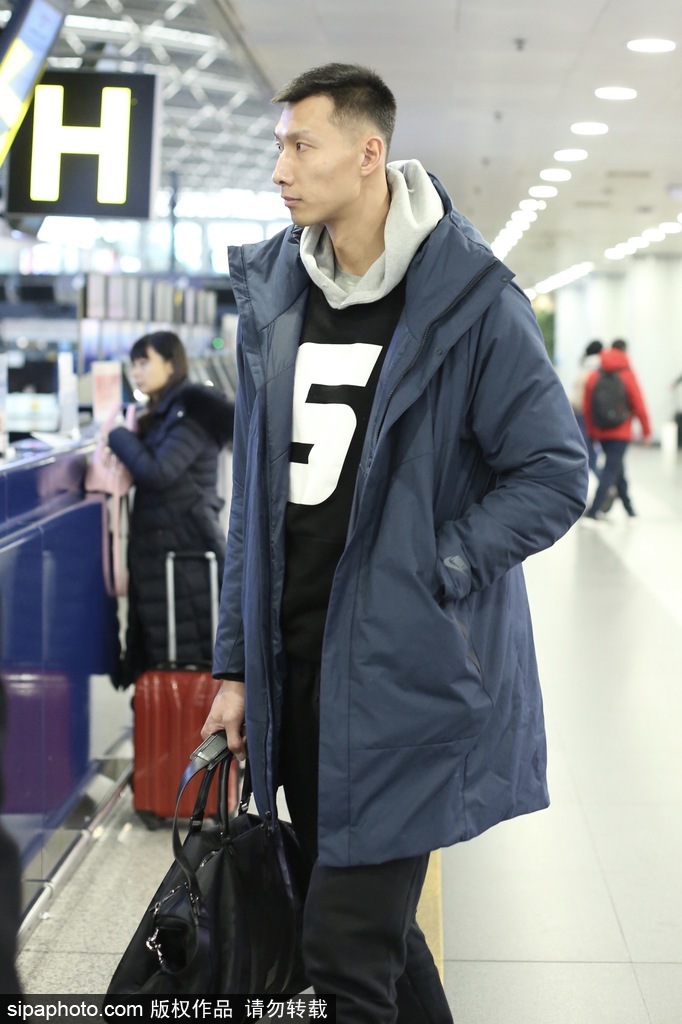 易建联戴着时尚墨镜现身机场，黑色休闲外套配潮裤，大步流星间气场全开，仿佛将机场走成了篮球赛场