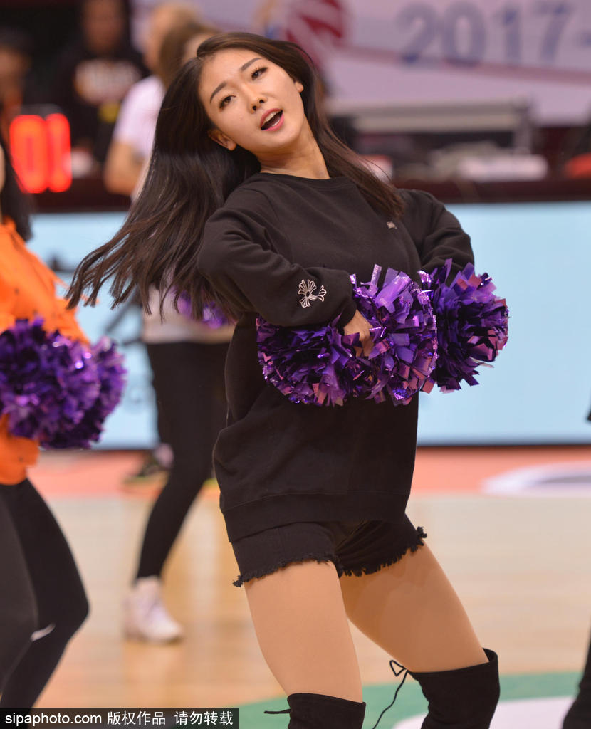 排练现场，一位扎着干练马尾的啦啦队员正在进行托举练习，她稳稳地站在队友们用手臂搭建的平台上，张开双臂保持平衡，脸上洋溢着从容与自信。