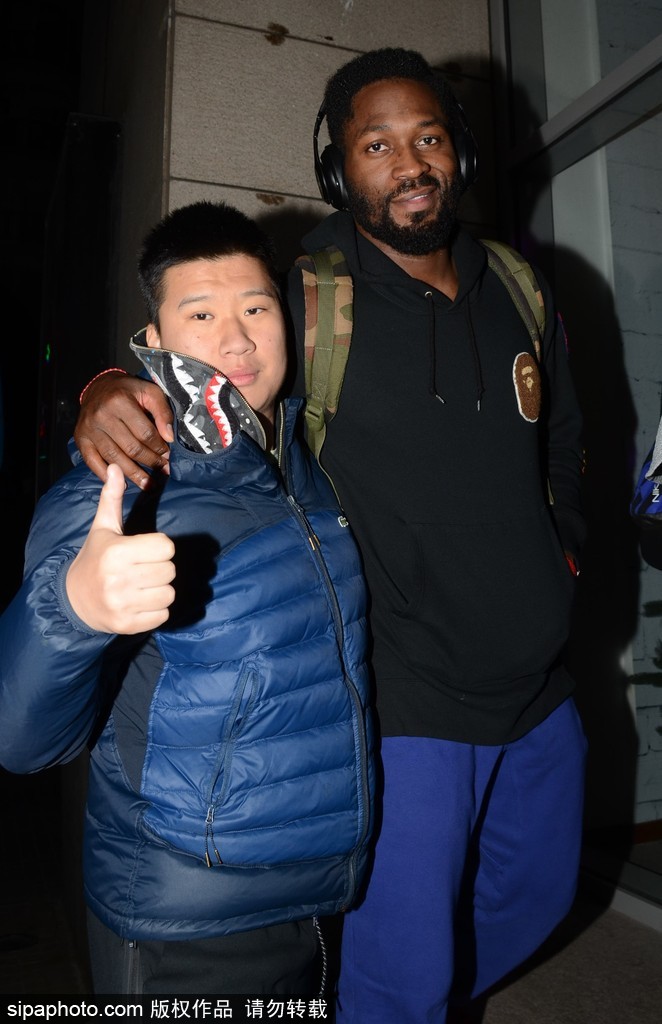 球队核心唐正东面带标志性的憨厚笑容，耐心地为一位小球迷在篮球上签名，小球迷仰着头，眼睛里满是崇拜的光芒，身后的人群自动让出一片小小的空间，让这温馨的一刻得以完成。