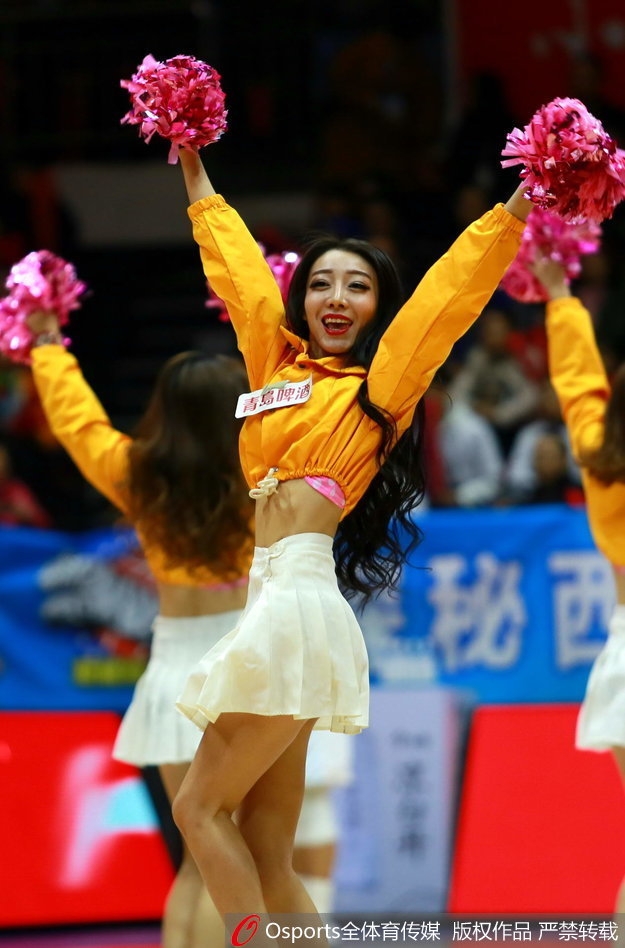 新疆飞虎啦啦队的宝贝们身穿亮黄色短裙，在球场上整齐列队，高扎的马尾辫随着预备动作轻轻摆动，青春气息扑面而来。