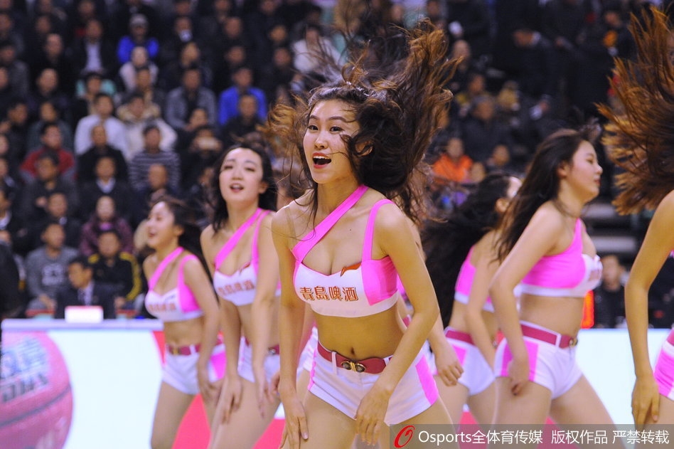 篮球宝贝们变换队形,侧身对着镜头展现出优美的身体曲线和整齐的舞蹈动作,她们手持花球,在球场地板的映衬下显得活力四射