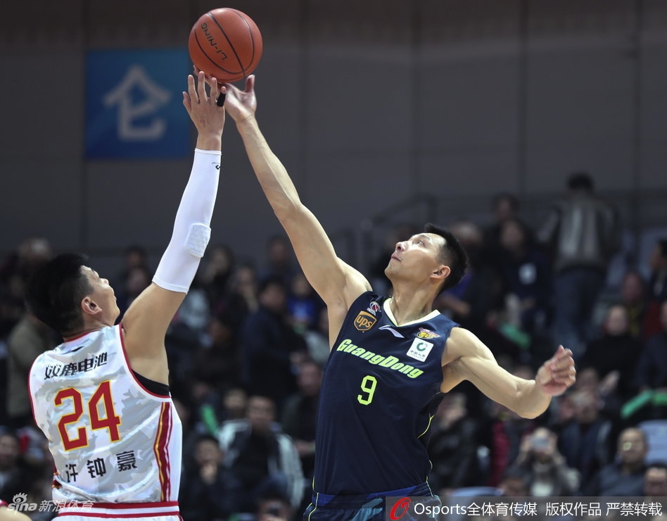 易建联在八一队内线群中高高跃起,以一记势大力沉的单手劈扣终结进攻,场边的摄影记者纷纷捕捉这震撼一刻。