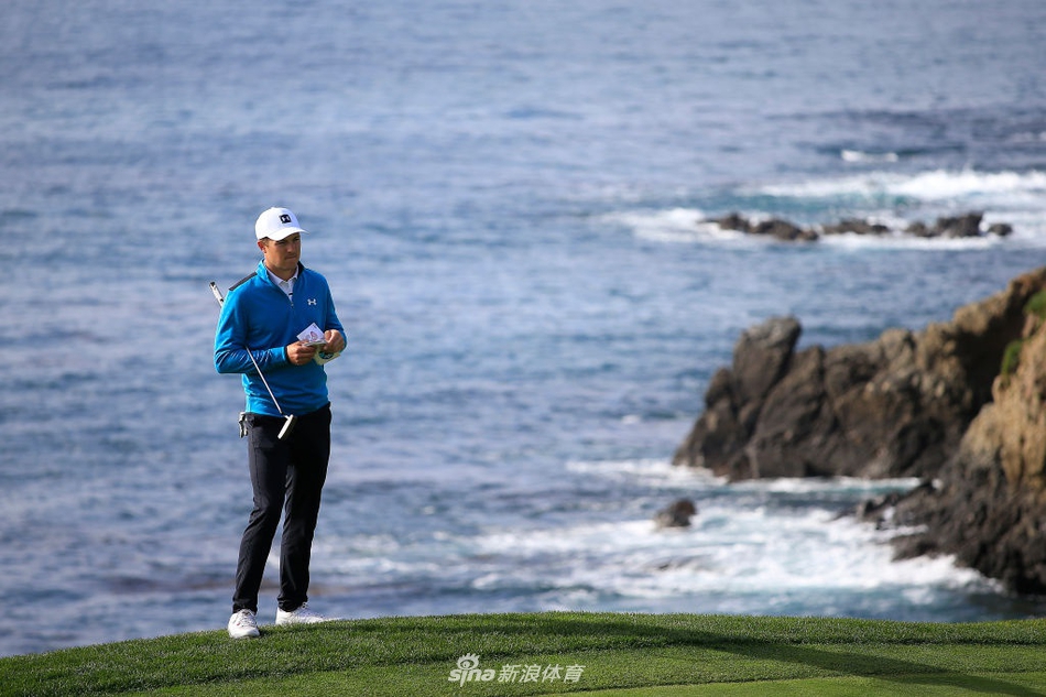 加拿大选手尼克·泰勒高举冠军奖杯笑容灿烂，身后是圆石滩著名的标志性海岸景观