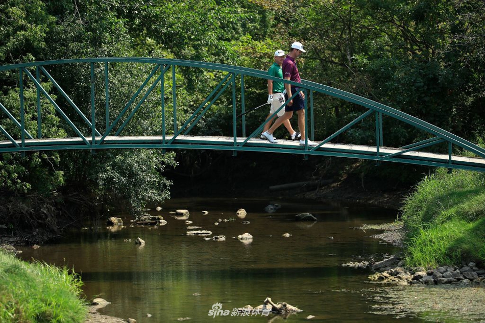伍兹与球童在练习中共同评估下一杆的击球线路与策略选择