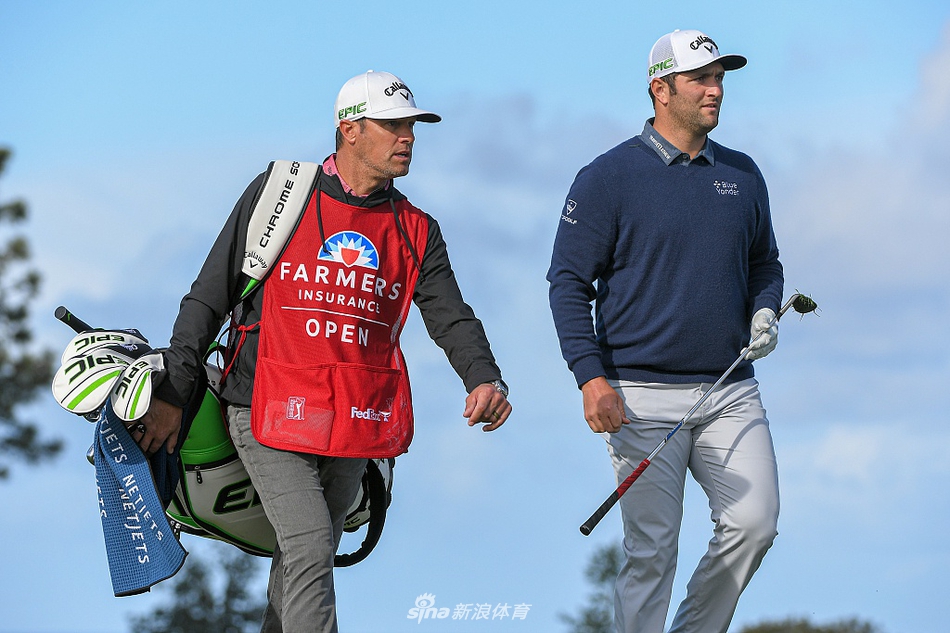 麦克罗伊在冰雹间隙中凝视球道，表情专注，帽檐下是冷静分析战局的目光。