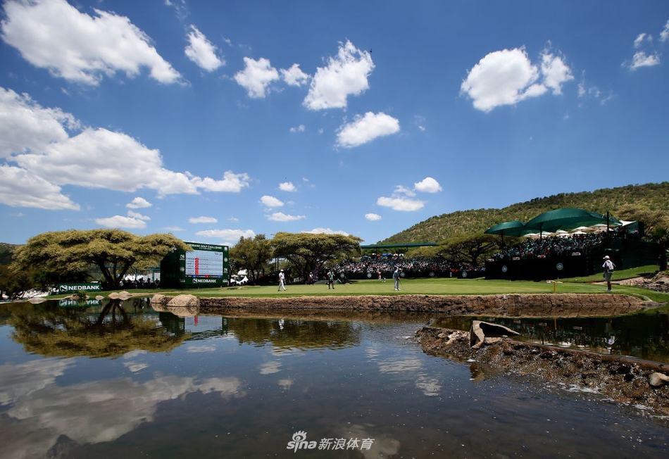 观众聚集在标志性洞旁的山坡上，沉浸于顶级高尔夫对决的紧张氛围中