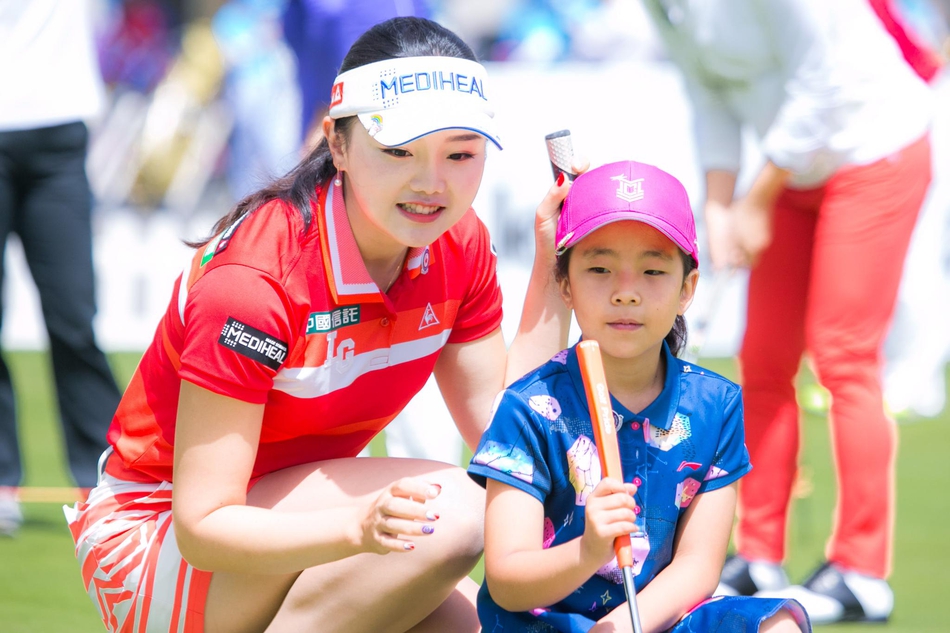 刘宇婕专注地看着石昱婷,石昱婷则面带甜美笑容,耐心地与小妹妹分享经验