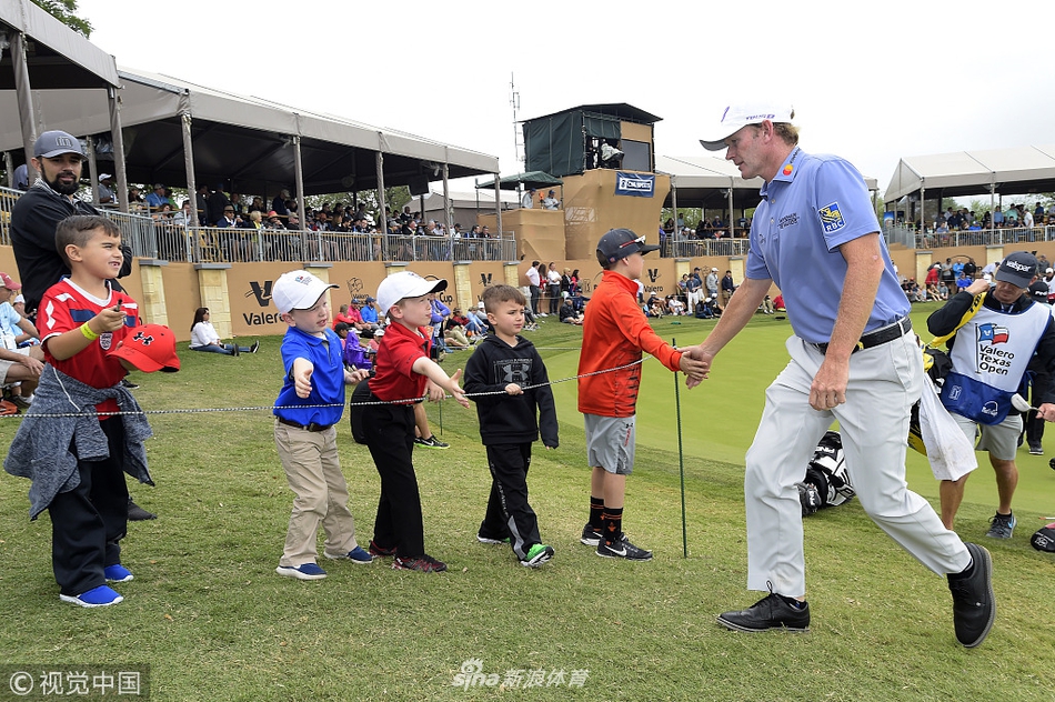 扎克-约翰逊与球童在球道上认真讨论选杆策略，两人的专注神情体现了职业赛场的严谨与团队合作。