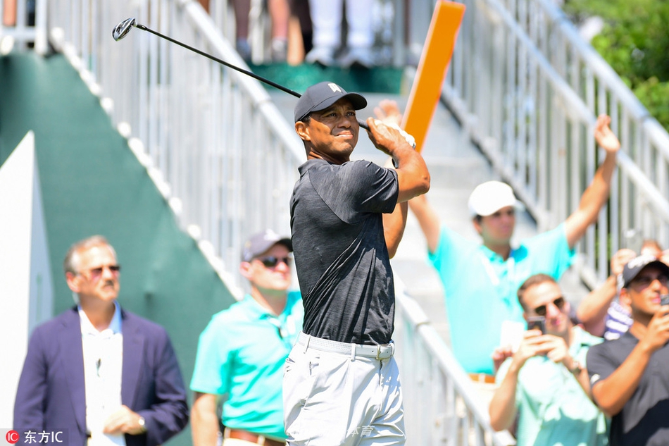 伍兹完成推击后,目光紧随小球滚动的轨迹,眼神中混合着期待与一丝紧张。