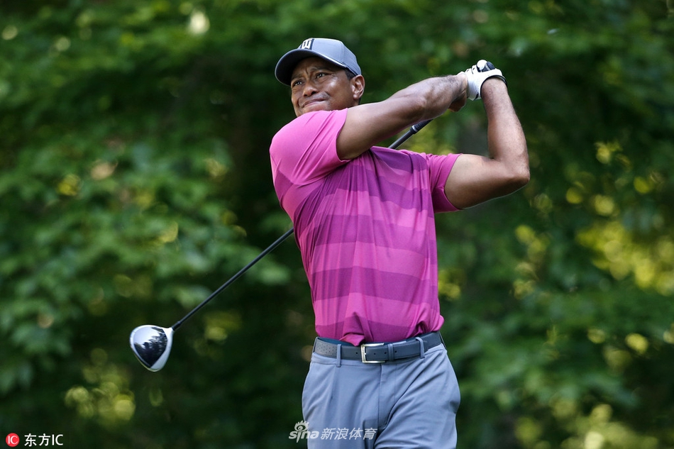 伍兹在开球台上完成一次漂亮的一号木挥杆，身体扭转充满力量感，目光紧随小球飞行的轨迹