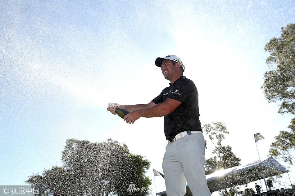 福克斯捧起造型独特的冠军奖杯向观众致意，奖杯在阳光下熠熠生辉，见证荣耀瞬间。