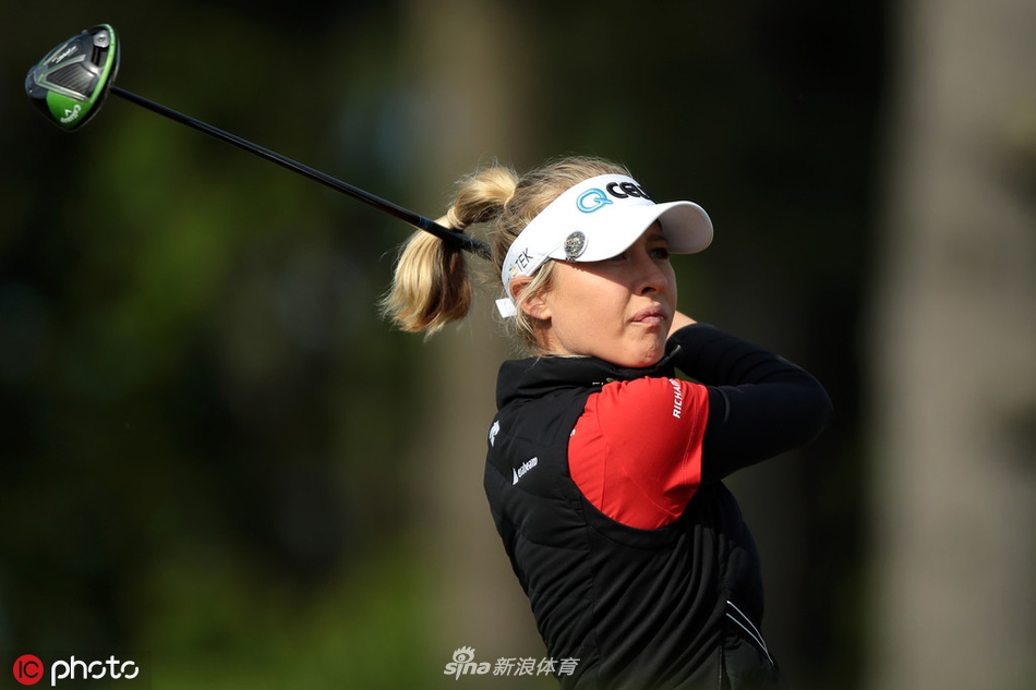 同组球员在果岭上共同研究复杂的推杆线路，阳光将她们的身影拉长，气氛紧张而专注。