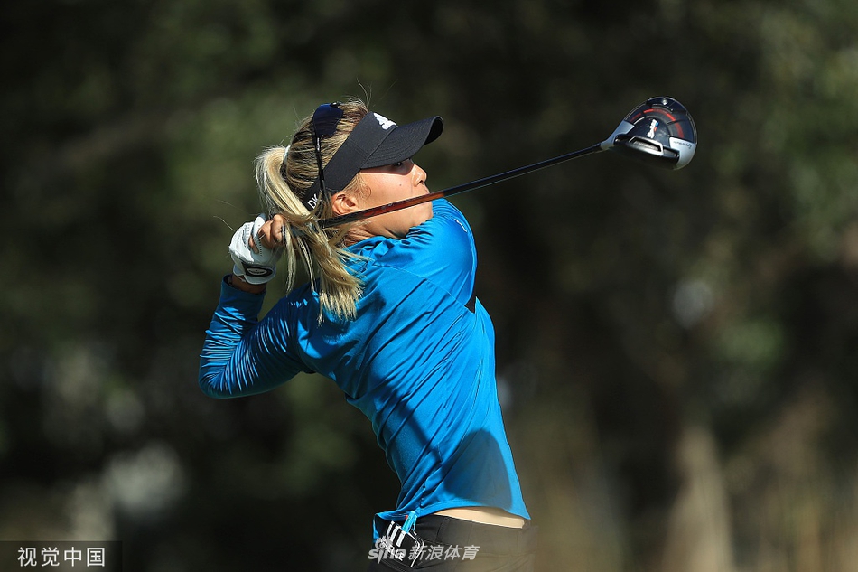 冠军金世煐在新闻发布会上手持奖杯微笑，面对媒体镜头，分享夺冠路上的心路历程。