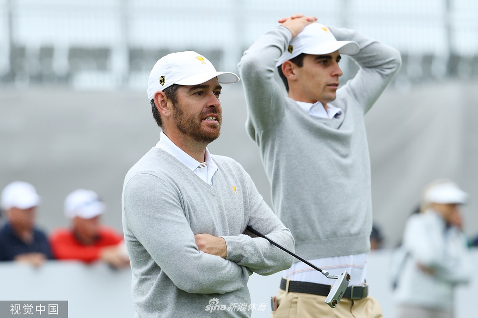 黄昏下的皇家墨尔本球场全景，国际队的旗帜在俱乐部会所前迎风飘扬，宁静中孕育着风暴