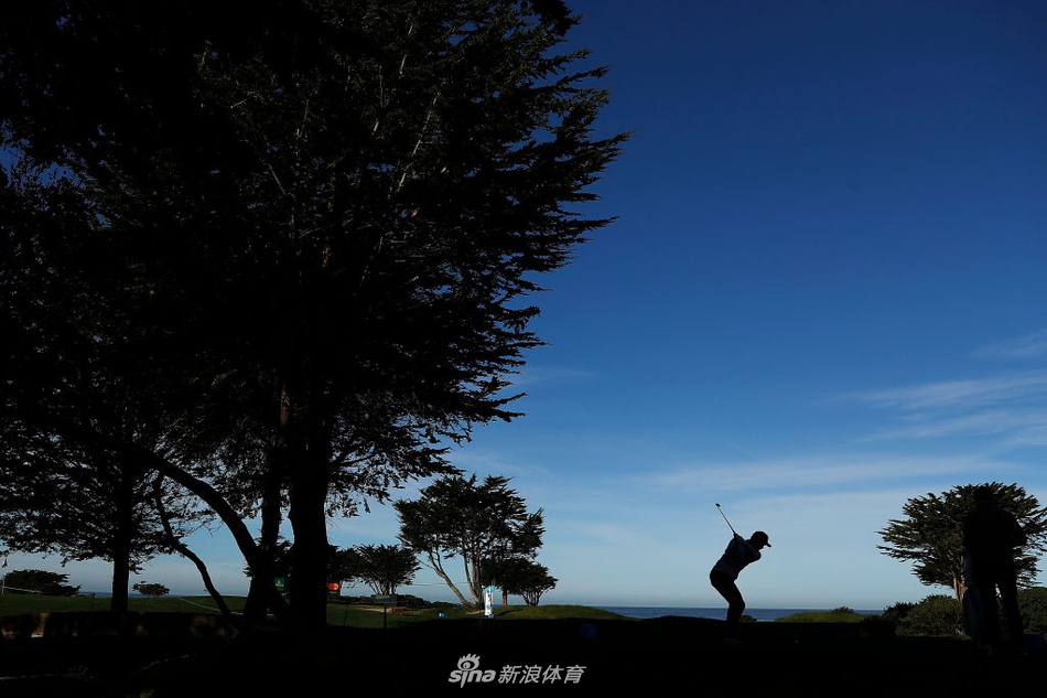 保罗·卡西站在发球台审慎观察球道布局，海风吹动他的衣角，神情冷静而专注