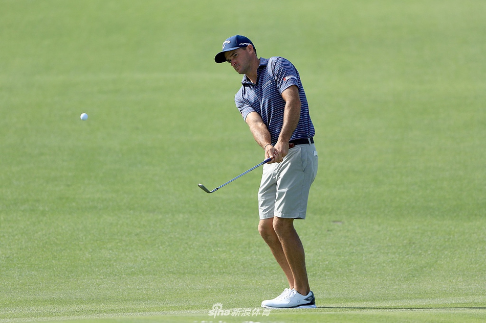 夕阳下的贝弗尔滕湖第18洞全景，湖水与挑战性的果岭相映，预示着即将到来的激烈角逐