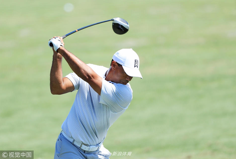 众多球迷聚集在练习场边，满怀期待地注视着偶像老虎伍兹的每一次挥杆