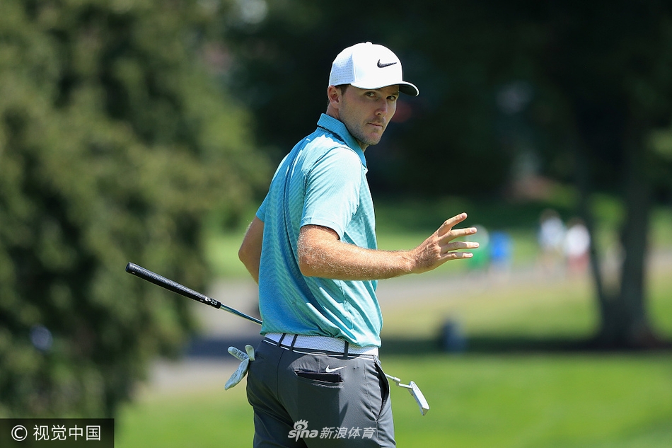菲尔·米克尔森在果岭边优雅收杆，目光随球飞向旗杆方向