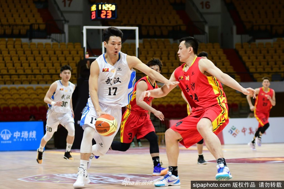 武汉当代队球员在三分线外果断出手，篮球在空中划出优美弧线，防守球员奋力起跳封盖，瞬间的爆发力与专注力在聚光灯下凝固。