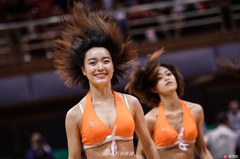 中场休息时，啦啦宝贝们排成整齐队列，用力挥舞花球掀起现场又一阵欢呼热浪