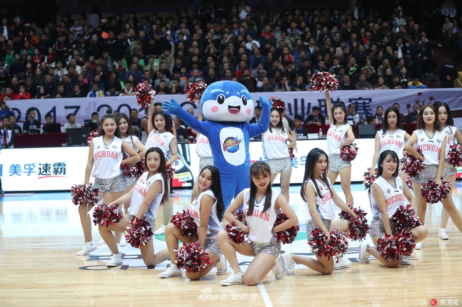 镜头拉近，一位笑容甜美的啦啦队员眼神明亮而专注，手中的花球随着节奏上下翻飞，每一个动作都充满了青春活力，仿佛在用自己的方式为场上的运动员加油鼓劲。