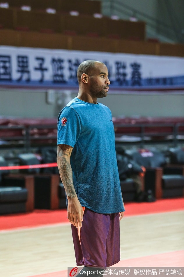 边路传中瞬间，进攻球员不顾防守飞身铲射，整个人横在空中，草屑随着动作飞扬