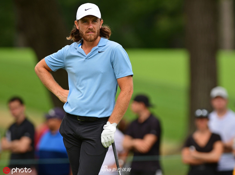 托马斯挥杆瞬间，阳光勾勒出流畅有力的身体线条与飞扬的草屑