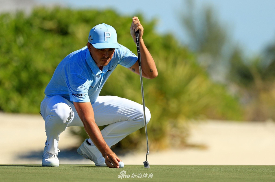 老虎伍兹在全神贯注地推击，背景是巴哈马标志性的碧海蓝天，王者气场笼罩全场