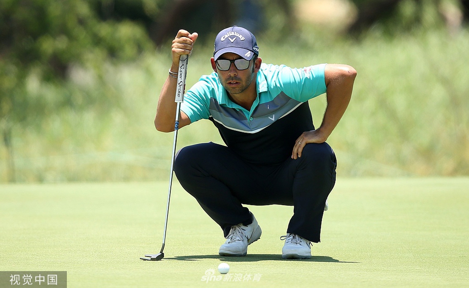 荷兰球手在沙坑中救球，沙砾飞扬的瞬间充满动感