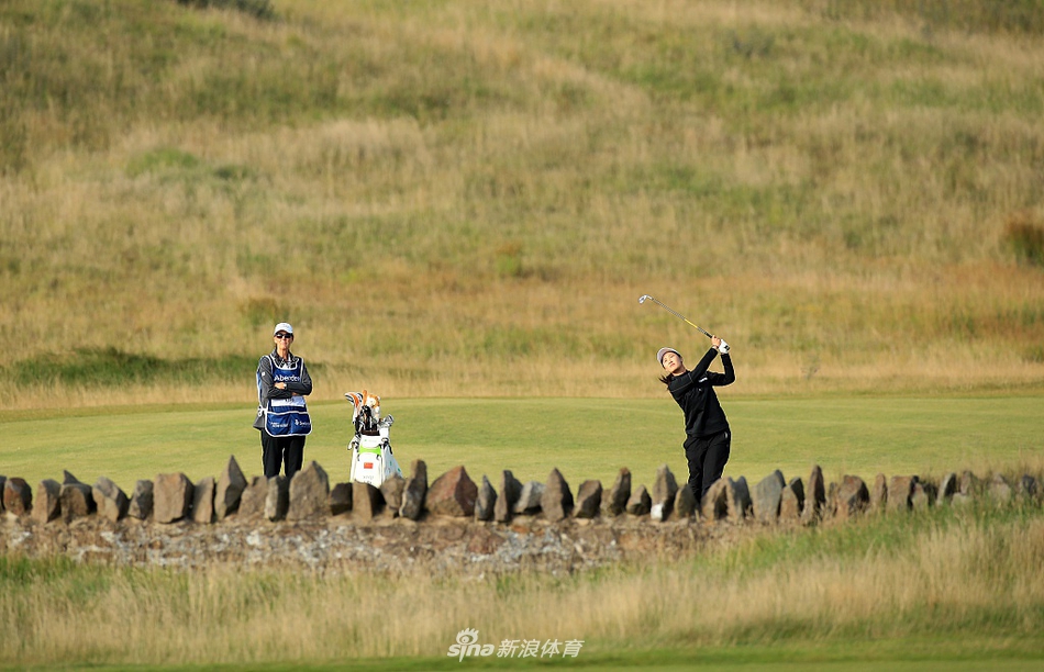 中国球员刘钰在起伏的球道上稳健挥杆，姿态优雅而充满力量