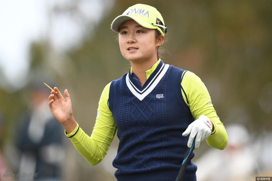 森田遥侧面挥杆特写，动作流畅完整，背景是朦胧的樱花树丛