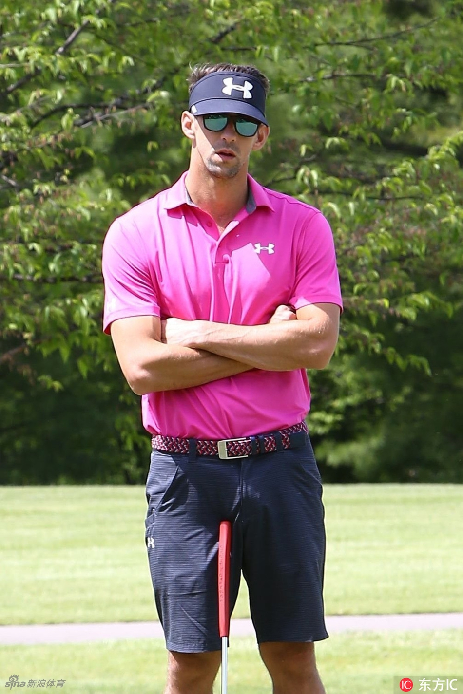 菲尔普斯与身旁的球童并肩行走在球道上，两人正进行轻松愉快的交流，氛围融洽。