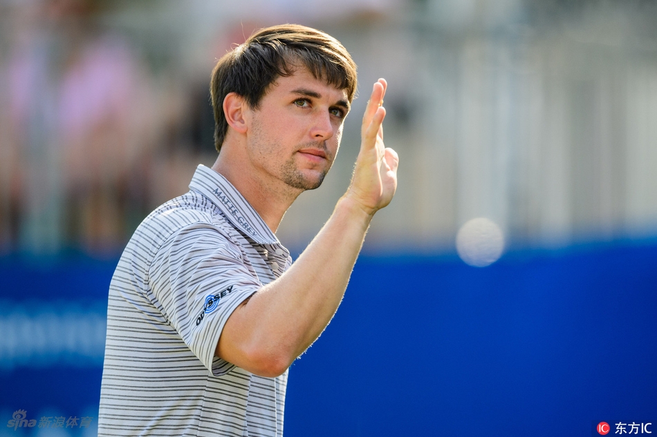 赛事观众聚集在果岭周边，屏息凝神观看球员推杆，赛场气氛紧张而热烈。