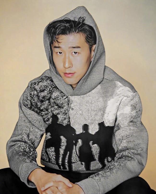 孙兴慜以一身简约的黑白配出镜，双手插兜，表情冷峻，通过强光与阴影的切割，突显出其立体的面部轮廓和坚定眼神