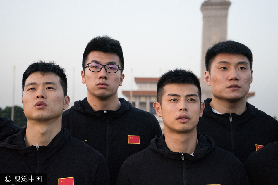 主帅李楠神情专注而严肃，他站在队列中，目光深邃地望向旗杆方向。作为曾经的国家队锋线尖刀，如今转型为“红队”掌舵人，他深知这一刻对这群年轻人的精神洗礼远比一场训练赛更加意义深远。