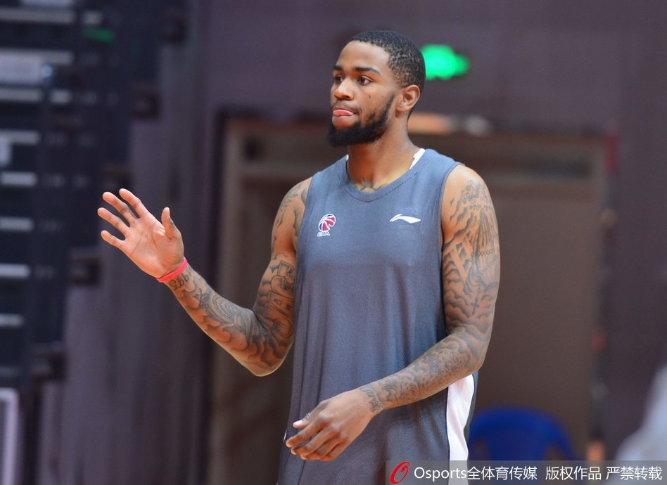 新疆队全体队员围成圆圈，肖恩朗站在中间双手握拳大吼，全队士气高涨，球鞋摩擦地板的痕迹记录着训练的艰苦