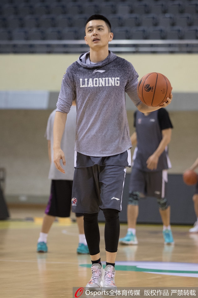 贺天举在队友防守下强行投篮，身姿矫健，对抗中毫不畏惧。