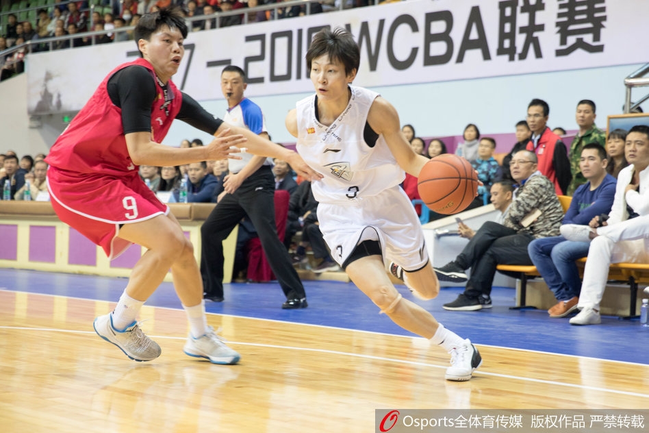 新疆女篮队长王丽丽面对防守悍将，毫不畏惧地运球强行突破。她压低重心，速度极快，犹如一把尖刀直插对手心脏地带。